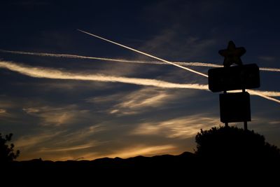 Low angle view of silhouette trees against sky at sunset