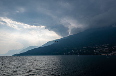 Scenic view of sea by city against sky