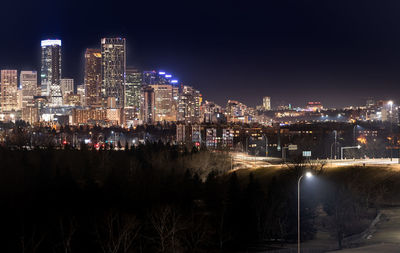 High angle view of illuminated buildings against sky at night