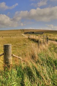 Hay bales on field against sky