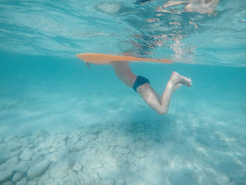 Low section of woman swimming in sea