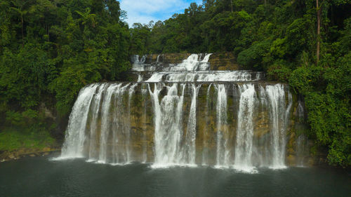 Beautiful waterfall in green forest, top view. tropical tinuy-an falls in mountain jungle