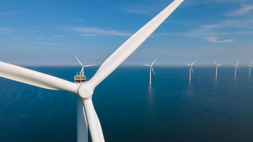 Low angle view of windmill against sky