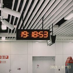 Low angle view of information sign on wall