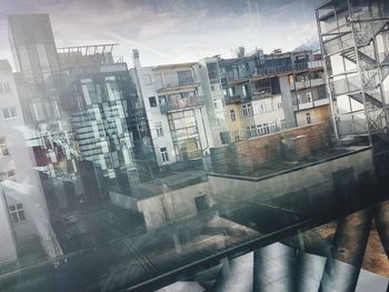 Digital composite image of buildings and street seen through window
