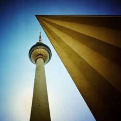 Low angle view of communications tower against sky