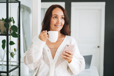 Portrait of young woman using mobile phone