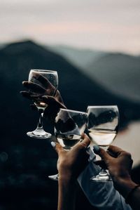 Midsection of girls holding wine glasses