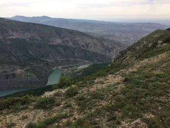 High angle view of river amidst mountains against sky