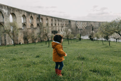 Rear view of child standing on field