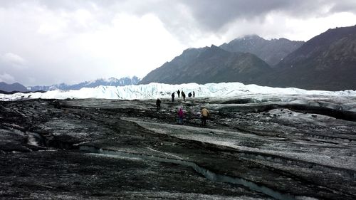 Scenic view of mountains against cloudy sky