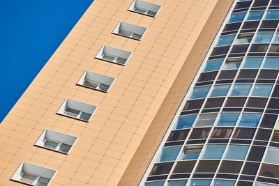 Low angle view of building against clear blue sky