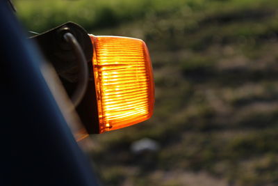 Close-up of illuminated yellow light on road
