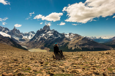 Rear view of man on mountain against sky