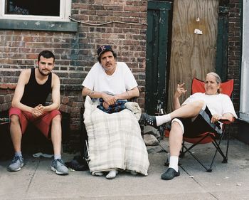 Young men sitting on chair