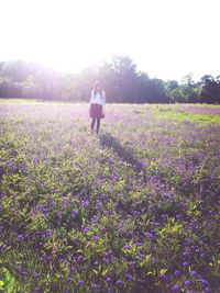 Rear view of woman standing in field