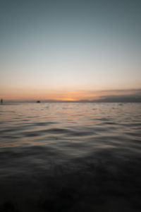 Scenic view of sea against clear sky during sunset