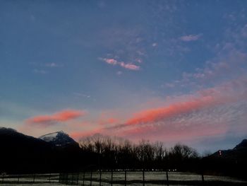 Scenic view of silhouette mountains against sky during sunset