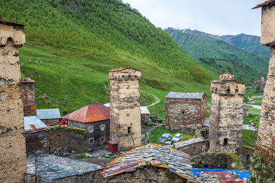 Old building by mountain against sky