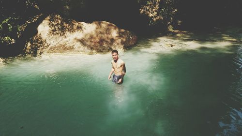 Full length of shirtless man in sea