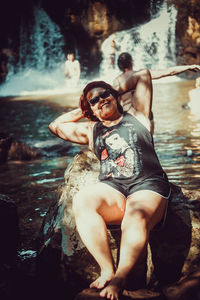 Portrait of woman sitting in water