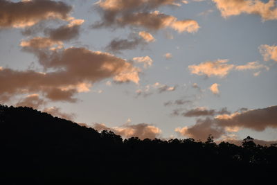 Silhouette of mountain against cloudy sky