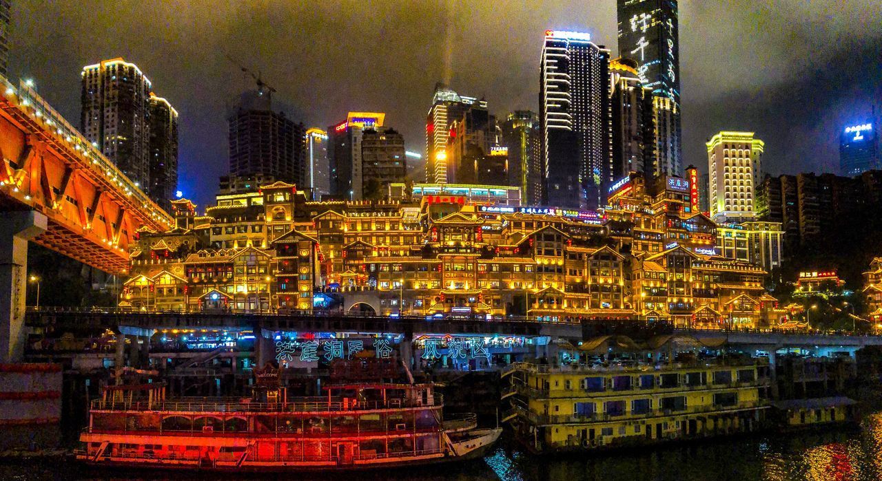 ILLUMINATED BUILDINGS AGAINST SKY AT NIGHT