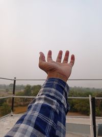 Midsection of person against clear sky