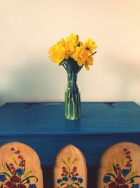 Close-up of yellow flower vase on table