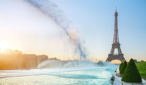 Fountain in city against sky