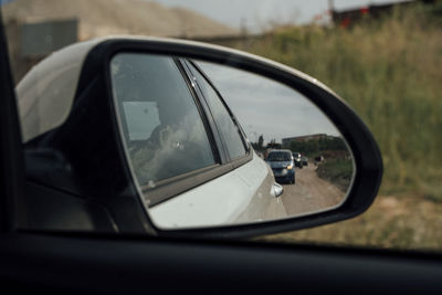 Reflection of car on side-view mirror