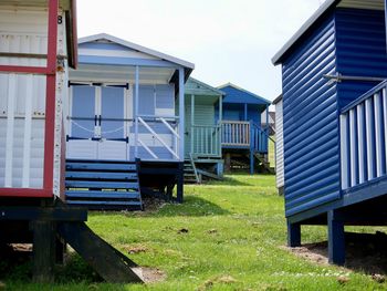 Houses on field against sky