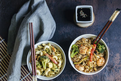 Bowls of pad thai noodles ready to be eaten