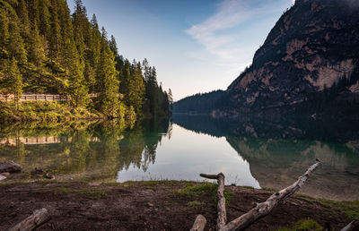 Scenic view of lake by mountains against sky