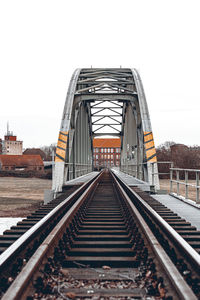 Surface level of railroad tracks against clear sky