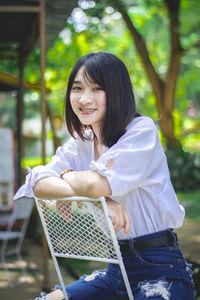 Portrait of a woman sitting outdoors