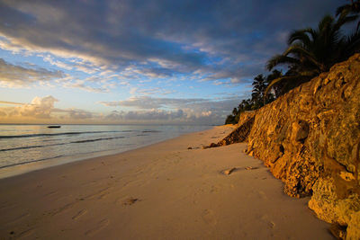 Scenic view of beach against sky during sunset