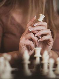 Close-up of hands playing chess