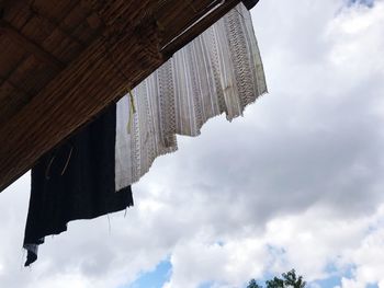 Low angle view of cross against sky