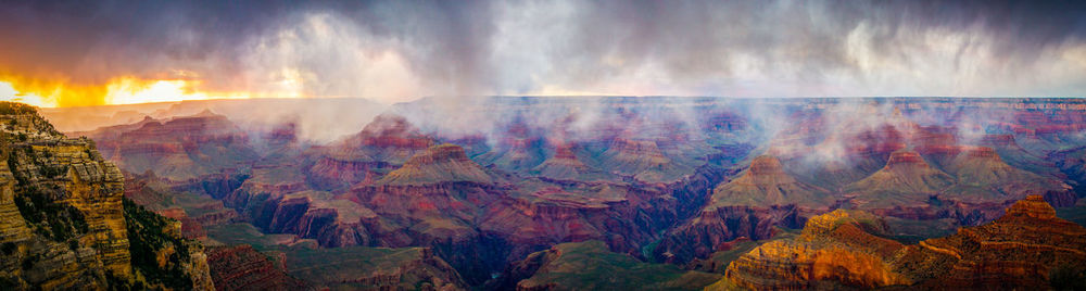 Panoramic view of sun shining over mountain