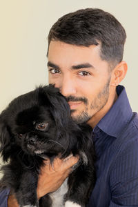 Portrait of woman with dog against white background