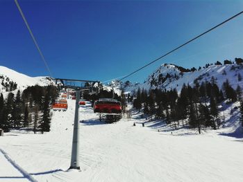 Low angle view of ski lift against clear sky