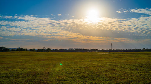 Scenic view of field against sky during sunset