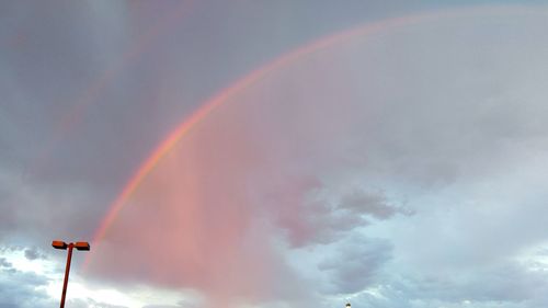 Low angle view of rainbow over trees