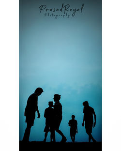 Silhouette people standing against sky