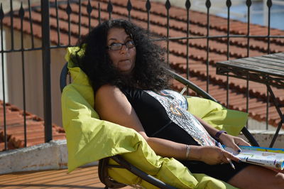 Portrait of woman sitting on bench