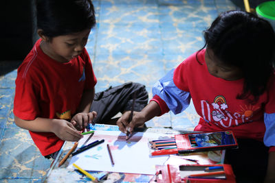 Rear view of people holding traditional clothing