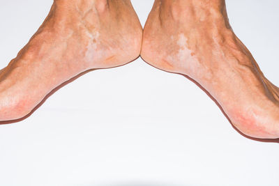 Low section of man against white background