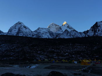 Scenic view of snowcapped mountains against clear blue sky