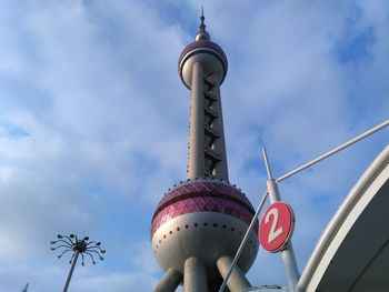 Low angle view of communications tower against sky